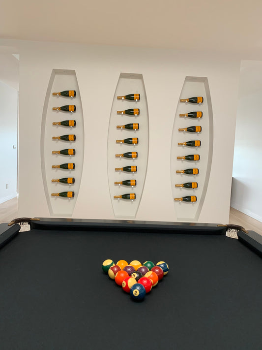 Champagne bottles on side on wall display in pool room