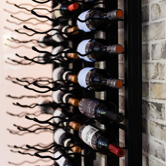 Wine rack up close with wine bottles on the side