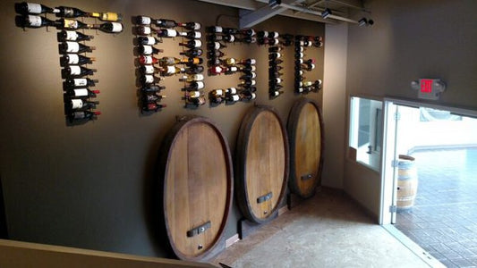wall of wine pegs, or vino pins, spelling out a name