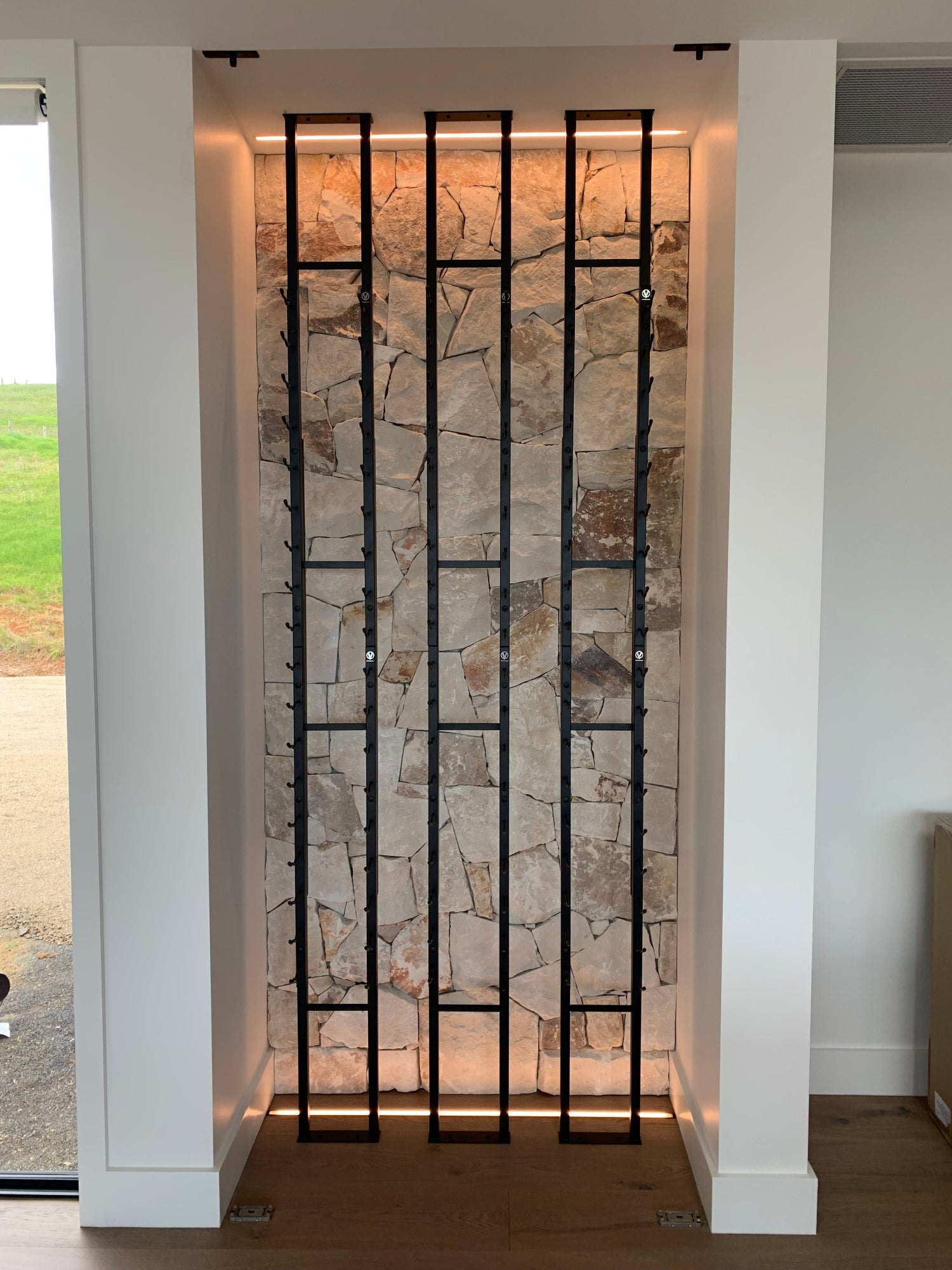 Modern wine cellar with stone surround and metal frame