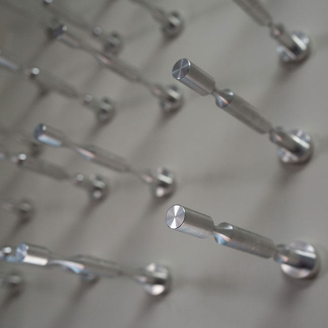 a grid of vino pins on a wall for wine storage