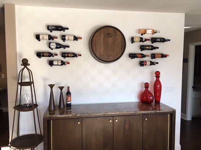 Small wine rack display on wall with vino pins